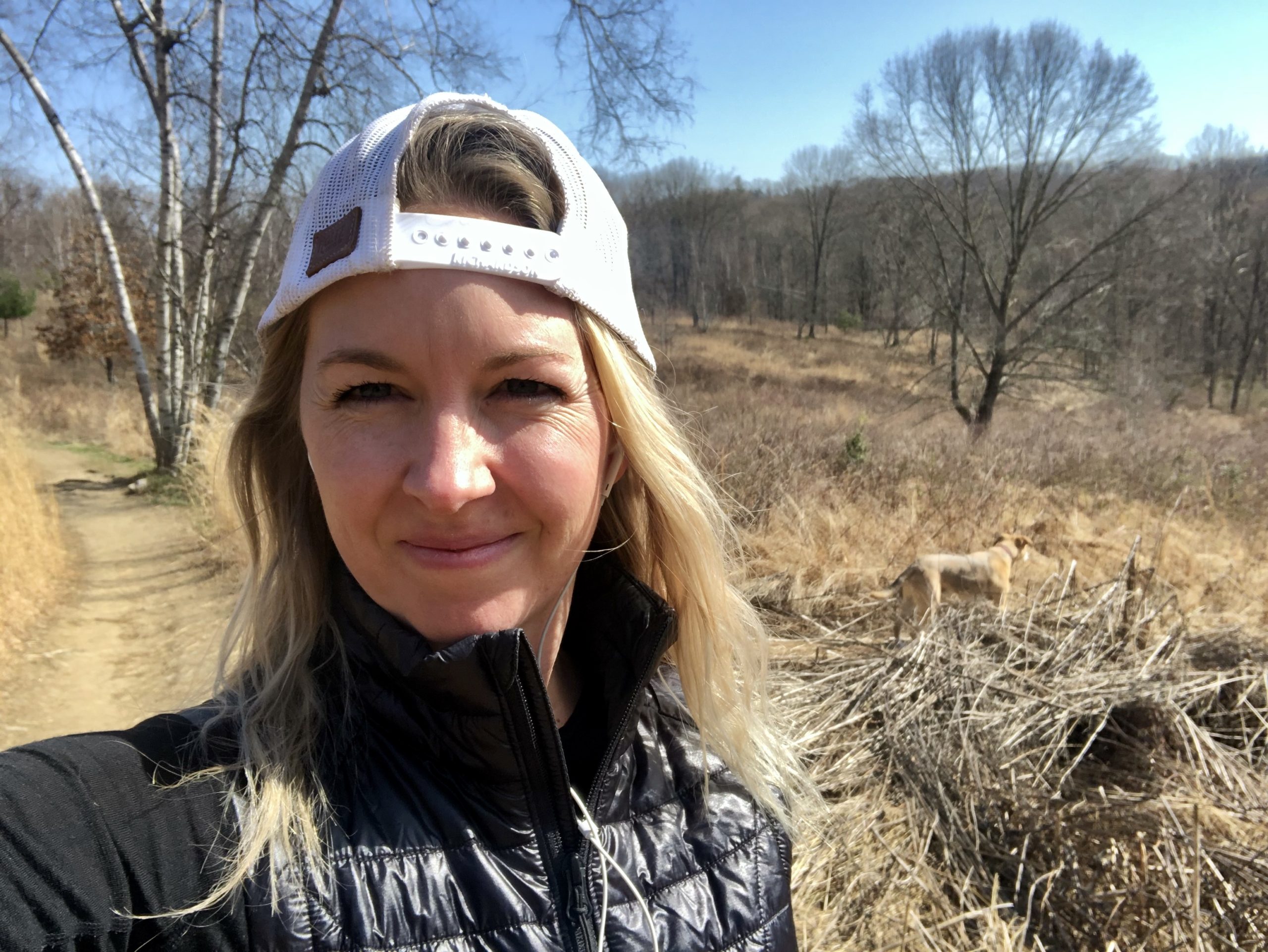 Board Member Erica Montemayor stands in an open woodland during winter